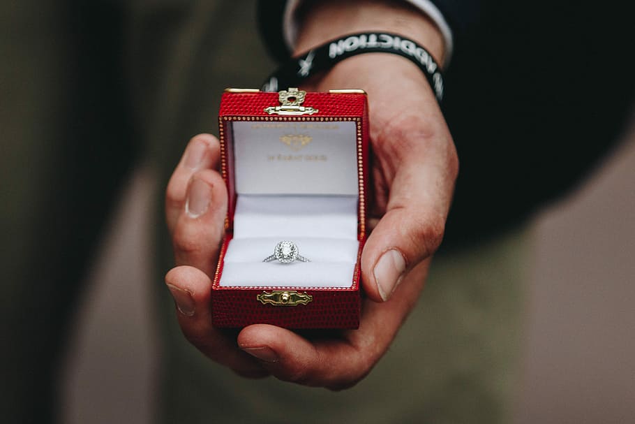 person, bedrift, boks, sølvfarvet ring, klar, ædelsten, tæt på, fotografering, ædelsten sølvfarvet prinsesse-skåret ring, hånd, ring, foreslå, forslag, diamant, fyr, kærlighed, bryllup, rød, engagement, sommer, engagment, menneskelig hånd, en person, voksen, menneskelig kropsdel, smykkeskrin, midsection, smykker, gave, indendørs, forlovelsesring, Kvinder, emotion, livsbegivenheder, fest, positive følelser, kasse - container, 5K