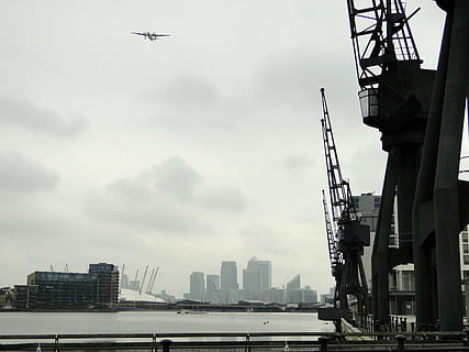 loading crane, cranes, port, crane, harbour crane, technology, industry, lifting crane, inner harbour, harbour area, architecture, load crane, industrial crane, building, skyline, london, england, united kingdom, built structure, building exterior, transportation, sky, city, mode of transportation, flying, air vehicle, water, nature, day, airplane, no people, cityscape, cloud - sky, travel, low angle view, tall - high, outdoors, office building exterior, skyscraper, financial district, 2K, CC0, public domain, royalty free