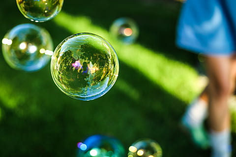 shallow, focus photography, soap bubbles, depth, field, photography, bubbles, grass, reflection, outdoors, bubble, bubble wand, shiny, green color, selective focus, mid-air, human body part, tree, spectrum, sphere, nature, focus on foreground, transparent, plant, fragility, vulnerability, soap sud, one person, close-up, lightweight, human limb, 5K, CC0, public domain, royalty free