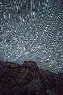 time-lapse photography, stars, dark, mountain, pattern, rocks, rocky mountain, time lapse, star trail, star - space, long exposure, motion, nature, night, astronomy, no people, outdoors, beauty in nature, space, scenics - nature, sky, tranquility, tranquil scene, blurred motion, environment, rock, rock formation, galaxy, formation, concentric, 5K, CC0, public domain, royalty free