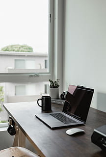 turned, laptop computer, wall, turn, laptop, black, mug, desk, work, workplace, workspace, office, home office, light, open, camera, plant, coffee, minimal, minimalist, technology, tech, computer, gray, grey, home, table, wireless technology, indoors, window, connection, home interior, day, communication, furniture, no people, cup, food and drink, drink, focus on foreground, still life, 4K, CC0, public domain, royalty free
