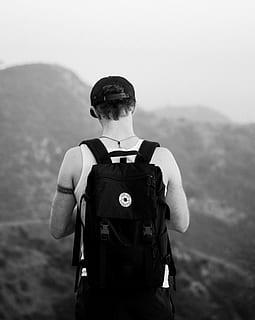man, standing, facing, mountains, wearing, backpack, travel backpack, white, tank, top, snapback cap, black, grayscale, photography, rucksack, guy, male, hiking, outdoors, men, adventure, people, nature, one Person, mountain, males, adult, uniform, work helmet, military uniform, army, real people, focus on foreground, rear view, security, sky, clothing, protection, day, occupation, safety, government, waist up, looking at view, 4K, CC0, public domain, royalty free