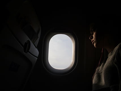 person, sitting, inside, aircraft, window, woman, wearing, gray, sweatshirt, taking, photography, near, airplane, dark, airline, people, girl, travel, trip, flight, transportation, one person, adults only, journey, adult, looking through window, one man only, side view, mode of transportation, vehicle interior, air vehicle, looking, waist up, nature, mid adult, contemplation, profile view, outdoors, watching, 4K, CC0, public domain, royalty free