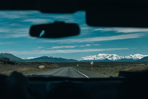 snow covered mountain, landscape photo, asphalt road, lands, front, mountain alps, road, mountain, windscreen, window, glass, transportation, car, mode of transportation, windshield, environment, vehicle interior, sky, glass - material, landscape, cloud - sky, scenics - nature, nature, car interior, motor vehicle, no people, sign, land vehicle, direction, outdoors, road trip, car point of view, 5K, CC0, public domain, royalty free