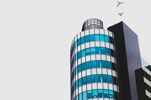 low-angle photography, glass building, gray, clouds, architecture, building, infrastructure, structure, establishment, apartment, windows, condominium, hotel, building exterior, modern, low angle view, built structure, skyscraper, no people, clear sky, day, sky, copy space, office building exterior, nature, office, city, tower, tall - high, outdoors, pattern, 5K