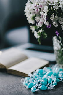 blue, candy, Book, flower, flowers, essentials, opened book, books, blue candy, bouquet, table, decoration, nature, plant, vase, flower Head, close-up, no People, arrangement, jewelry, wedding, precious gem, luxury, flowering plant, still life, focus on foreground, selective focus, white color, indoors, green color, day, wealth, paper, publication, personal accessory, 4K, CC0, public domain, royalty free