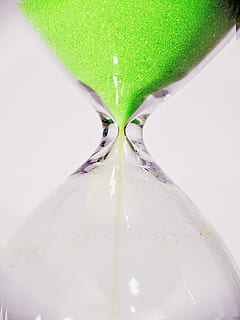 close-up photo, hourglass, temporal distance, chronometer, duration, egg timer, style, period, fughit, interval, phase, sand, range, hour, tempus, clock, time of, while, white, time, lag, time difference, tense, timepiece, amount of time, indoors, close-up, land, no people, green color, white background, still life, nature, studio shot, single object, transparent, falling, deadline, water, motion, instrument of time, 1080P, CC0, public domain, royalty free