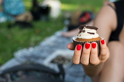 hand, Cupcake, cake, chocolate, dessert, hands, outside, pastry, sweet, people, outdoors, human Hand, holding, day, focus on foreground, one person, close-up, human body part, sweet food, food and drink, food, freshness, indulgence, real people, body part, lifestyles, temptation, nail, finger, 5K