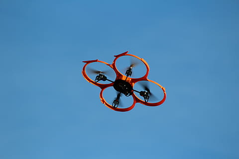red quadcopter, drone, flying object, model, remotely controlled, rotors, multicopter, sky, blue, clear sky, low angle view, copy space, nature, no people, day, outdoors, circle, shape, red, sunlight, geometric shape, directly below, sunny, metal, design, art and craft, cut out, 2K, CC0, public domain, royalty free