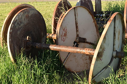 roll, empty, rusty, agriculture, summer, out of date, leave, old, grass, field, land, nature, plant, day, no people, metal, outdoors, green color, sunlight, abandoned, landscape, cylinder, domestic animals, container, transportation, wheel, 5K, CC0, public domain, royalty free