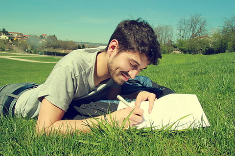 male, laying, grass, holding, pen, man in gray, shirt, man, field, spring, sun, prairie, nature, green, writing, written, young adult, one person, lying down, young men, plant, real people, casual clothing, leisure activity, lifestyles, land, green color, sunlight, day, lying on front, relaxation, outdoors, teenager, 5K, CC0, public domain, royalty free