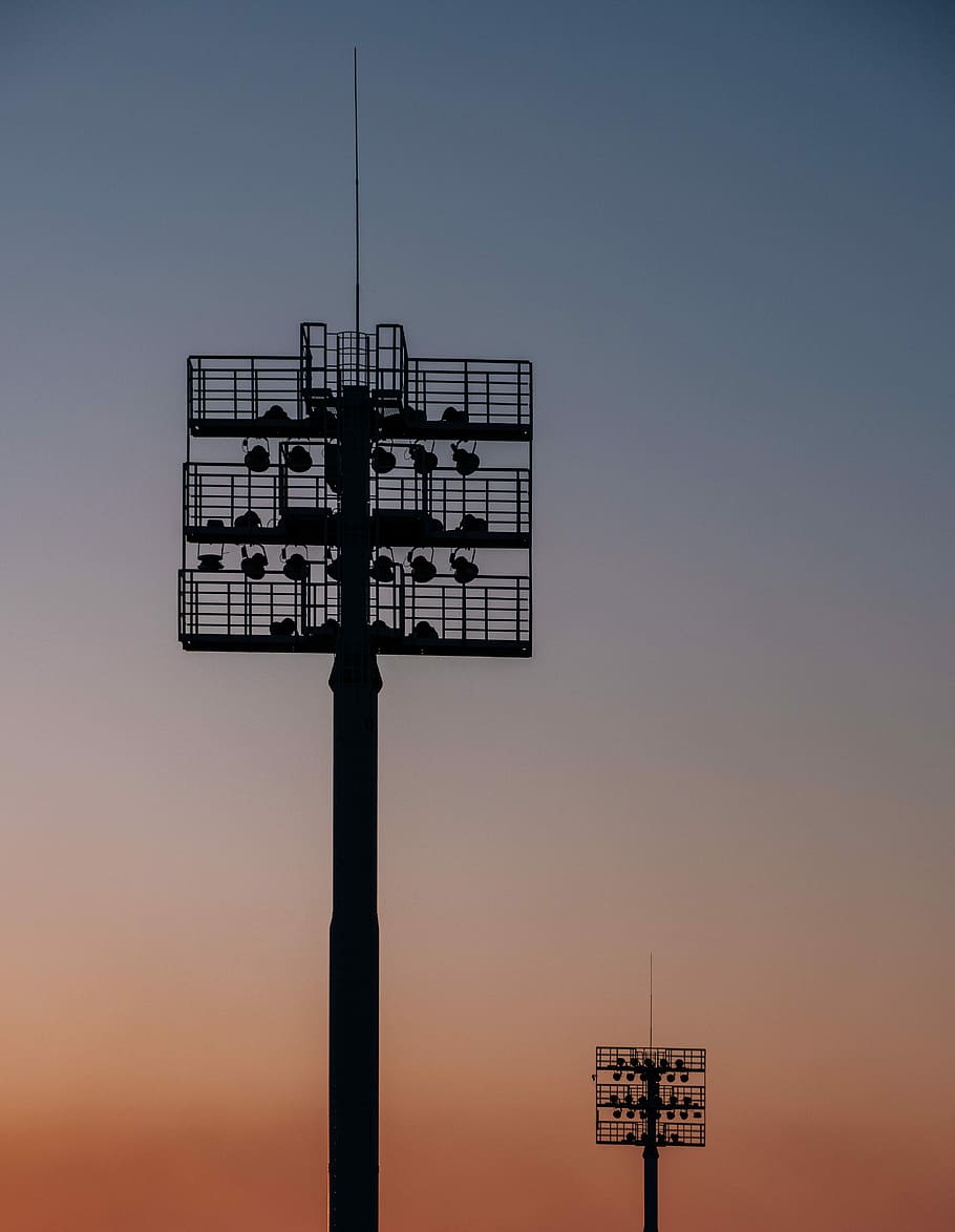två, metalltorn, lampor, gyllene, timme, ljus, stadion, skymning, solnedgång, skugga, himmel, inget folk, natur, teknologi, byggd struktur, arkitektur, lågvinkelvy, silhuett, kommunikation, Pol, klar himmel, kopiera utrymme, utomhus, förbindelse, ljusutrustning, elektricitet, strålkastare, torn, 5K