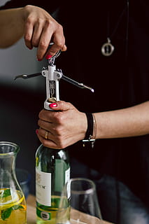hands opening wine bottle, corkscrew, Hands, opening, wine bottle, female, woman, bottle, wine, alcohol, white wine, opening wine, cork, human Hand, men, people, drink, holding, one man only, human body part, one person, hand, indoors, midsection, focus on foreground, close-up, real people, container, adult, refreshment, food and drink, cork - stopper, finger, 4K