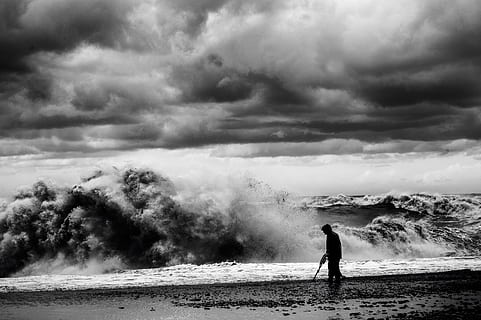 grayscale photo, man, walking, seashore, silhouette, shore, huge, waves, cloudy, sky, mountain, sea, wave, cloud, beach, coast, cloud - sky, one person, water, nature, beauty in nature, land, standing, day, power in nature, men, power, smoke - physical structure, scenics - nature, environment, outdoors, 4K, CC0, public domain, royalty free
