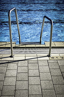 water, pattern, tiles, swimming, pool, blue water, empty, outdoors, pavement, poolside, steel, swimming pool, railing, metal, no people, day, high angle view, staircase, nature, ladder, footpath, architecture, sunlight, tile, sea, tiled floor, paving stone, 2K, CC0, public domain, royalty free